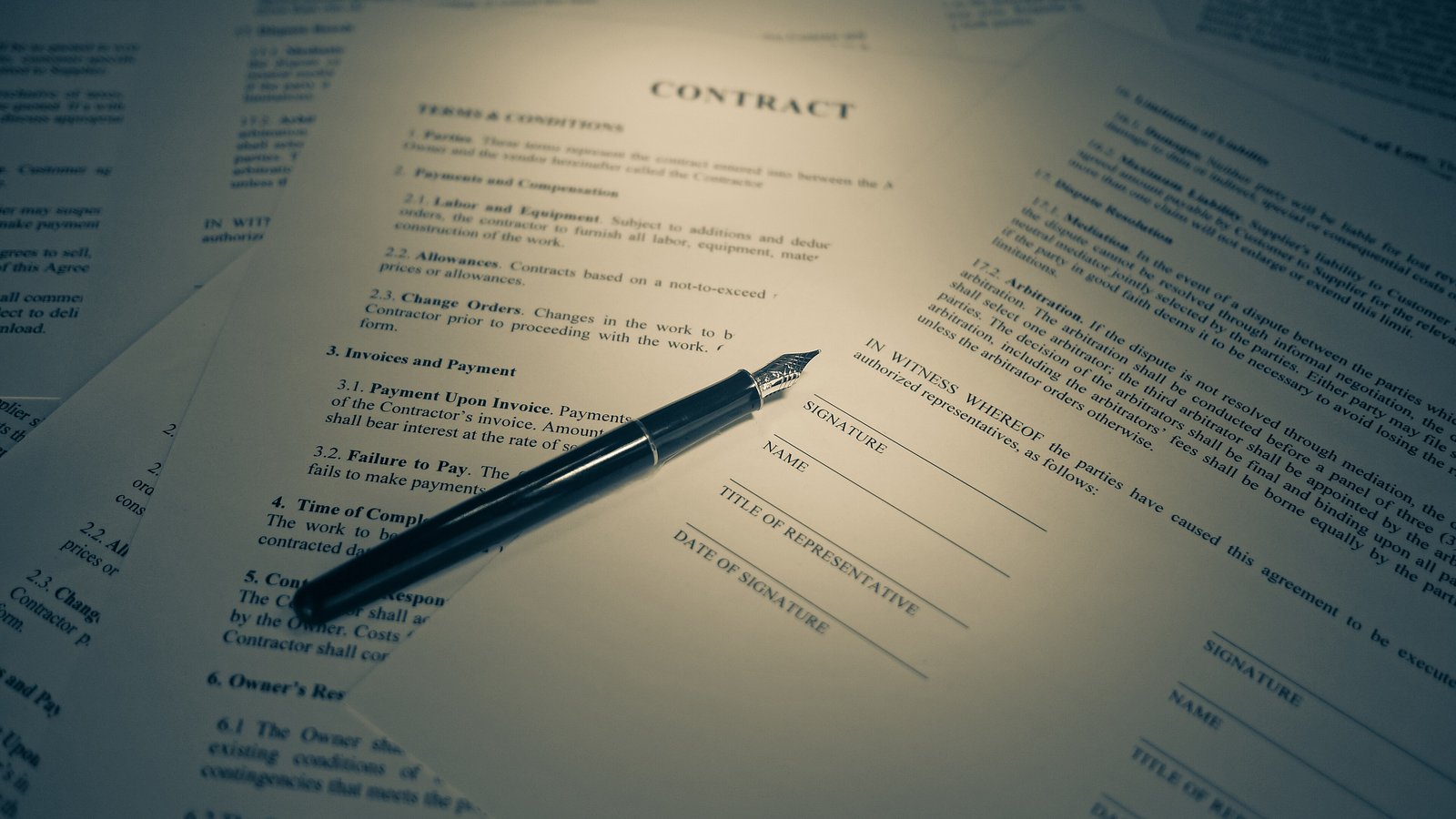 Contract pages with fountain pen, warm tones
