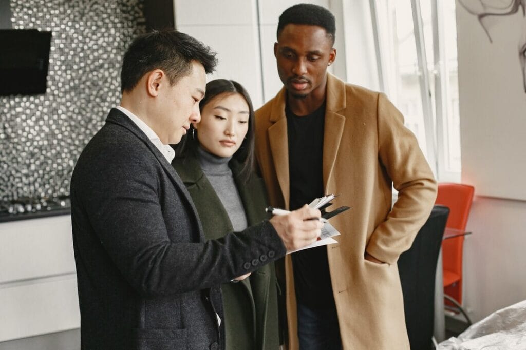 young-couple-buying-new-house-asian-woman-african-man-signing-documents-new-home_1157-47962